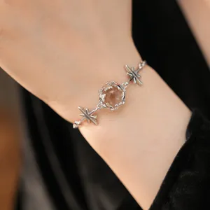 Detailed shot of elegant silver star bracelet with central clear glass bead on wrist