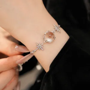 Detail view of a starburst bracelet with sparkling zircon and round glass element.