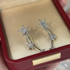 Detailed view of silver-tone shooting star earrings with sparkling cubic zirconia stones