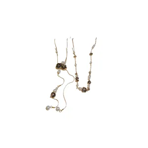 Vintage style necklace with black distressed roses and white pearls on gold chain