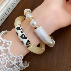 Bohemian acrylic bracelet set with pearl and polka dot details on wrist, elegant jewelry