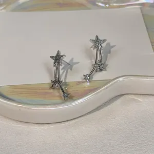 Elegant silver shooting star stud earrings featuring shimmering cubic zirconia detail