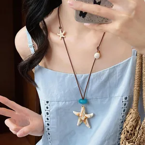 Bohemian starfish necklace with ocean-themed charms on a brown adjustable cord.
