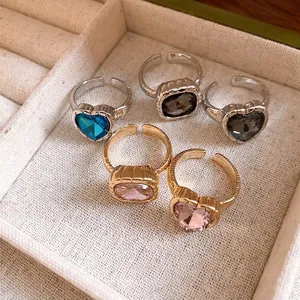 Collection of elegant heart-shaped and square rhinestone adjustable rings in a tray