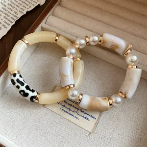 Close-up of Bohemian acrylic bracelets featuring marbled patterns and faux pearls
