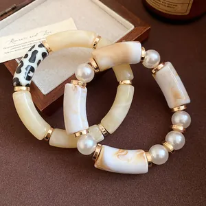 Detailed macro shot of Bohemian acrylic bracelet with leopard print and pearl accents