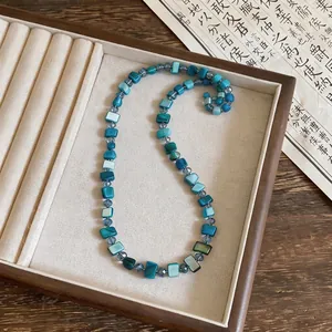 Artistic blue and teal square shell beaded necklace for seaside holiday style outfits