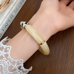 Close-up detail of an elegant Bohemian acrylic segmented bracelet with spotted patterns.