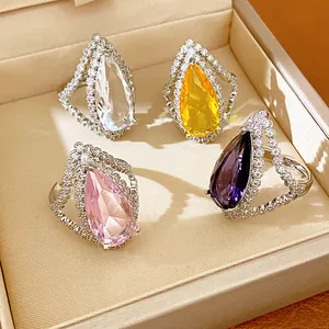 Detail view of four teardrop zircon rings in different colors inside a jewelry gift box