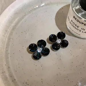 Elegant black floral stud earrings with a sparkling crystal center stone for women