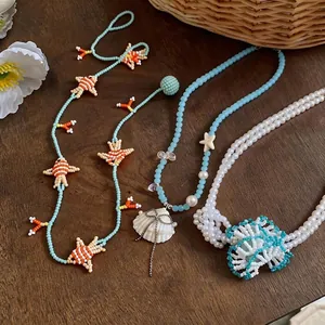 Handmade glass beaded fish and shell necklaces for a breezy summer vacation look