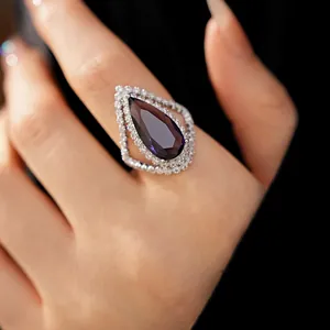 Macro detail of a luxurious pear-shaped purple zircon ring with double sparkling halo