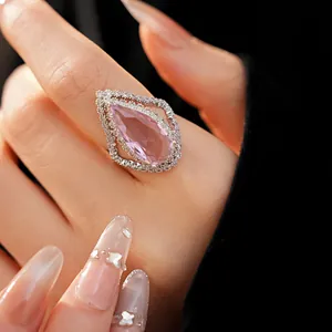 Detailed macro shot of a luxury pink teardrop zircon ring in vintage silver pave setting