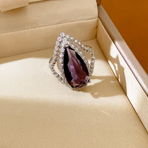 Exquisite teardrop purple zircon open ring with crystal halo presented in beige jewelry box