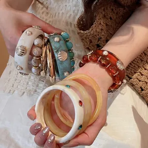 Vintage resin bangle set with gold shell and pearl accents in multiple chic colors