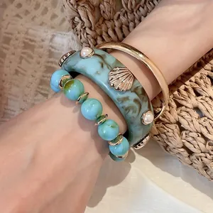 Three-piece turquoise resin bracelet set with shell and pearl accents for women