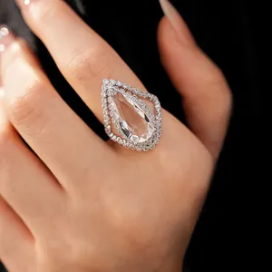 Macro view of a luxurious pear-shaped zircon ring with a vintage halo setting on a hand