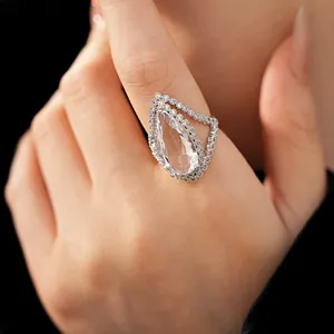 Elegant close-up view of a luxury pear-cut zircon halo adjustable ring worn on a finger