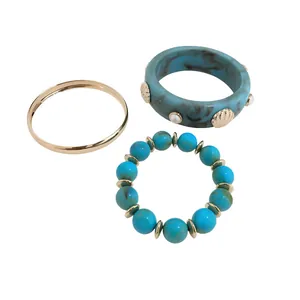 Fashionable resin marbling bracelet set with gold accents and blue beaded bracelet