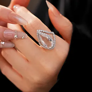 Elegant pear-cut cubic zirconia open ring with double halo pavé setting on hand