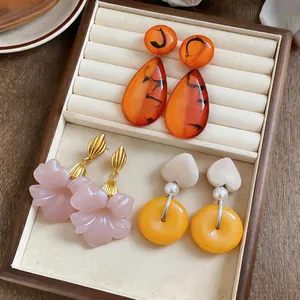 Variety set of vintage French resin earrings including flower and teardrop designs.