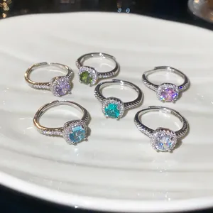 Detailed view of six adjustable silver rings with colorful round zircon gemstones