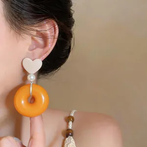 Detailed view of elegant French retro resin earrings with heart and orange donut design