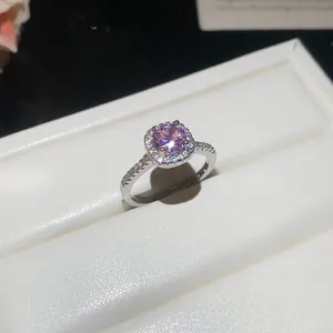 Close-up detail of a silver zircon ring featuring a sparkling pink round center stone