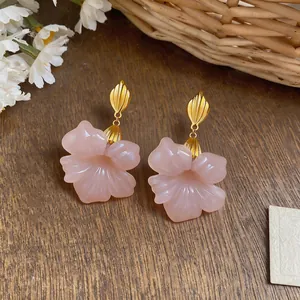 Detailed view of elegant pink resin flower earrings featuring vintage French gold details