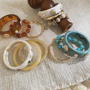 Bohemian resin bangle and beaded bracelet set with seashell and pearl details
