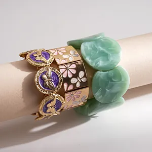 Close-up of retro butterfly enamel elastic bracelets and green acrylic hand jewelry