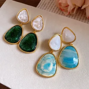 Elegant vintage resin teardrop earrings with gold-tone frames and marble texture