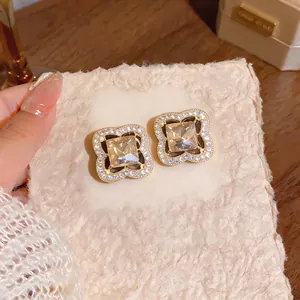 Luxury S925 silver needle flower stud earrings with champagne square crystals.