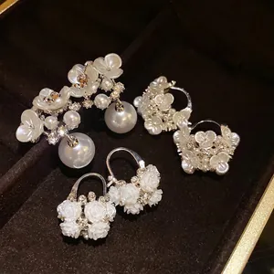 Elegant collection of vintage-style floral pearl earrings with shimmering rhinestone details