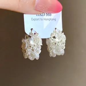 Elegant floral hoop earrings featuring delicate white pearls and sparkling crystals