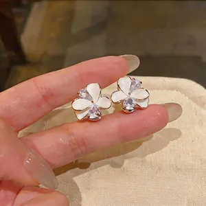 Elegant white petal flower stud earrings with sparkling zircon accents in rose gold tone