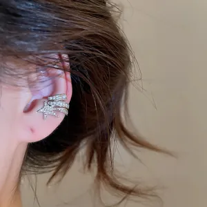 Macro detail of zircon star ear cuff showing shimmering stones and silver finish