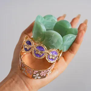 Detailed view of vintage butterfly enamel bracelet and green marble resin chunky bangle set