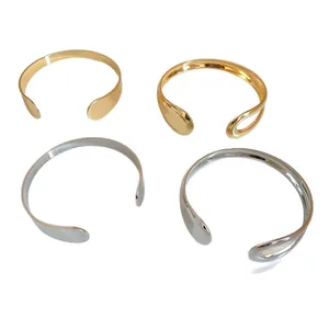 Minimalist irregular metal open cuff bangles in polished gold and silver finishes
