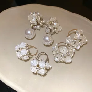 Close-up detail of elegant French vintage floral pearl drop and rhinestone earrings
