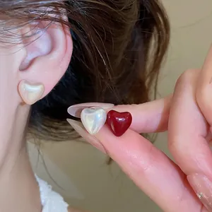 Elegant heart-shaped pearl stud earrings set featuring glossy red and cream finishes