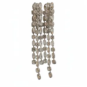 Sparkling geometric long tassel earrings with crystal rhinestones on white background