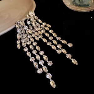 Detailed view of luxury silver tassel earrings with sparkling geometric rhinestones