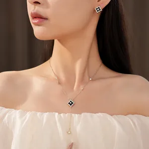 Close-up of elegant zircon rhombus star necklace and earrings set worn by a model