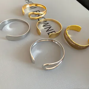 Assorted irregular metal open cuff bracelets in minimalist gold and silver finishes