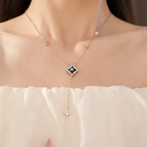 Elegant gold zircon rhombus star pendant necklace detail worn on neck with cream dress