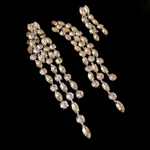 Exquisite sparkling rhinestone geometric long tassel drop earrings on a black background