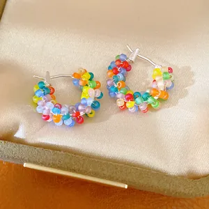 Detailed view of colorful handcrafted frosted beaded hoop earrings in a jewelry box