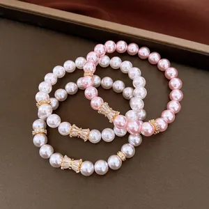 Set di braccialetti elastici con perle e zirconi ed eleganti ciondoli a fiocco