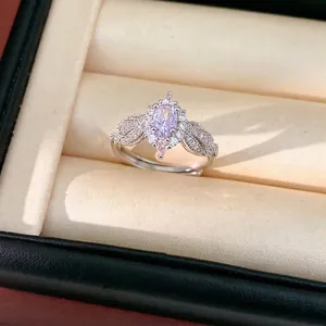 Elegant silver ring featuring a pink oval zircon center with vintage leaf design accents